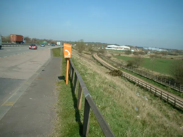 The A42: Footpath and road side by side Looking North Eastward from the embankment of the South bound carriageway of the A42. The footpath running alongside but